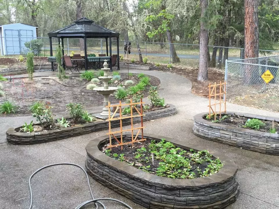 Older photo of the garden, walking path, and gazebo from when it was first built.